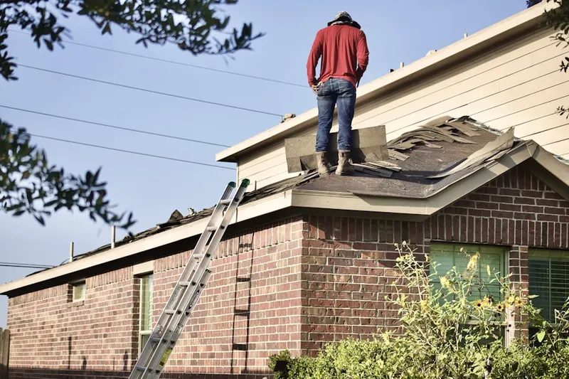 Professional roofer working on a residential roof in Davis